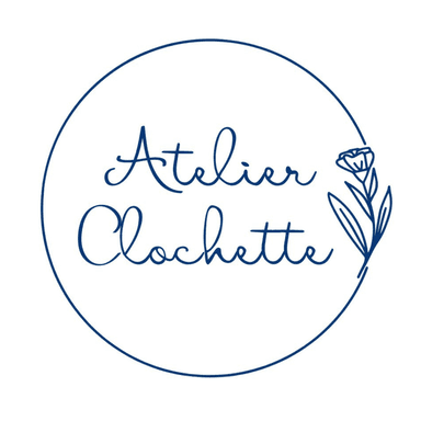 Atelier Clochette écrit en bleu dans une police d'écriture manuscrite, entouré d'un cercle bleu qui se ferme avec un dessin bleu de fleur sur tige. Art botanique, cyanotypes originaux et tirages uniques. Art mural inspiré par la nature, pour une décoration d'intérieur boho chic, bohème, champêtre, végétal et eco-friendly. Empreintes végétales et planches botaniques.